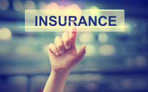 Insurance concept with hand pressing a button on blurred abstract background